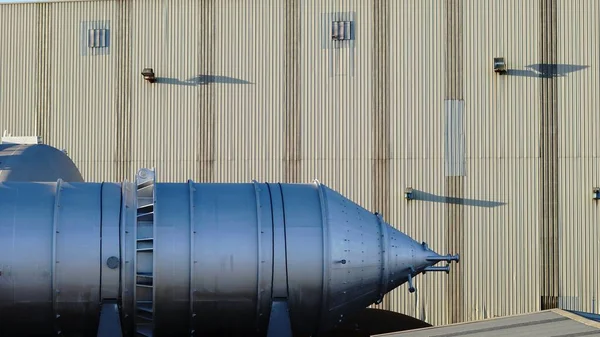 construction of steel tank against factory background