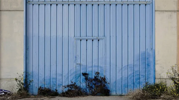 dirty blue metal door from industrial building