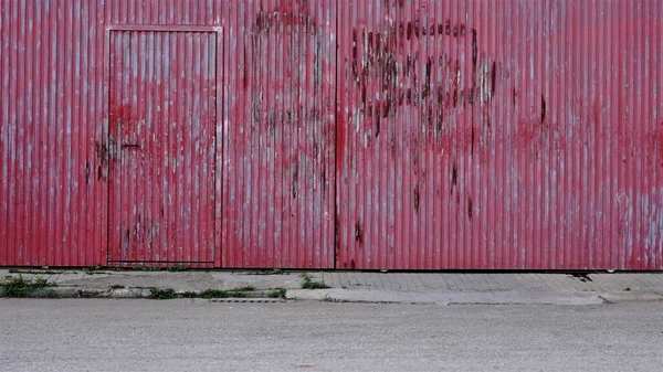 red damaged large industry door