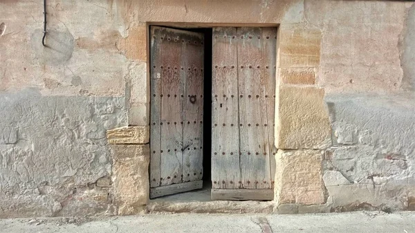 rustic wooden door open on old facade