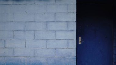 blue door on gray brick wall