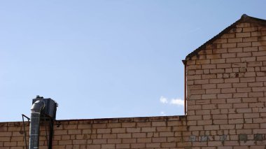 rustic warehouse facade against the sky