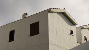 corner of rustic white house facade