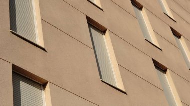 facade background with windows with blinds