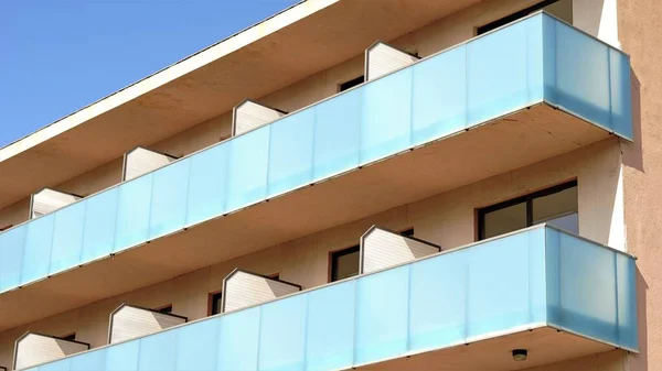 facade with glass balconies against the sky