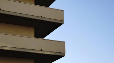 building profile with concrete balconies against the sky
