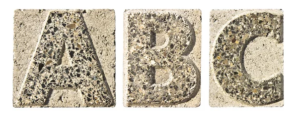 Letter A-B-C carved in a concrete block