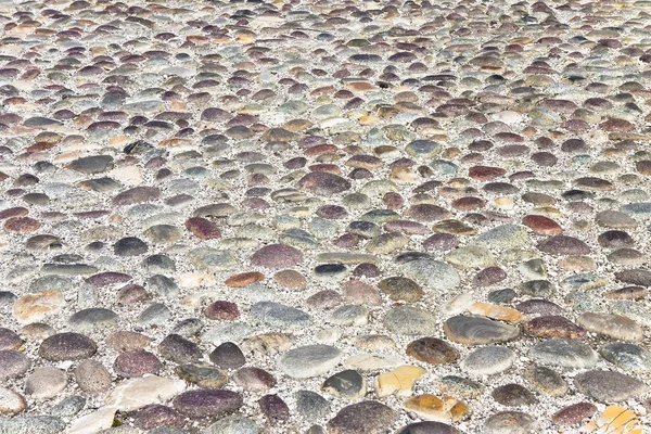 Detail of a pebble floor with dark polished stone — Stock Photo, Image