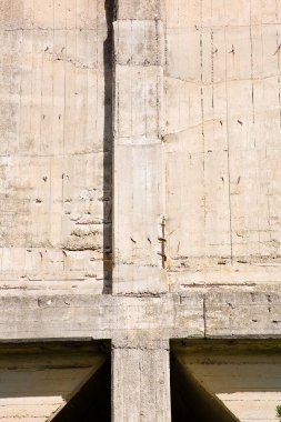 Hasarlı ve paslı metalik destek çubukları olan eski güçlendirilmiş beton yapı.