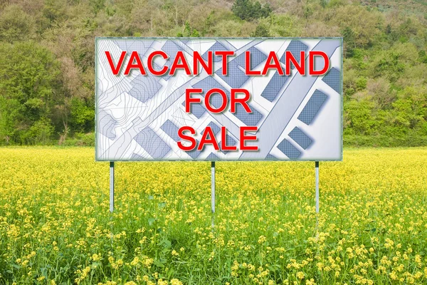 Advertising billboard immersed in a rural scene with Vacant Land for Sale written on it - concept with an imaginary cadastral map on background.