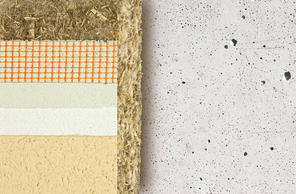 Thermal insulation coatings with hemp for building energy efficiency and reduce thermal losses against an old concrete wall - Building energy efficiency and savings concept image with copy space.