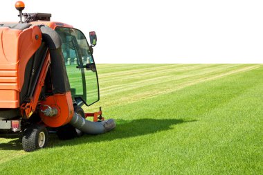 Ride on lawn mower cutting fresh grass - Image with copy space. clipart