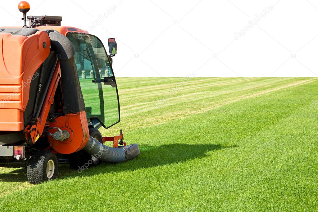 Ride on lawn mower cutting fresh grass - Image with copy space.