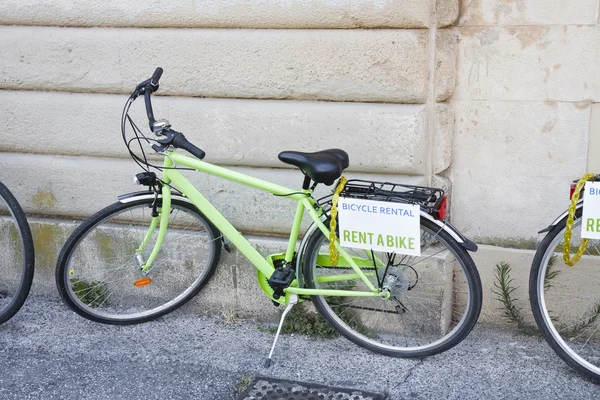 Bicicletta verde in affitto contro il muro — Foto Stock