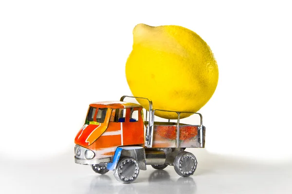 Small lorry loaded with one big lemon — Stock Photo, Image