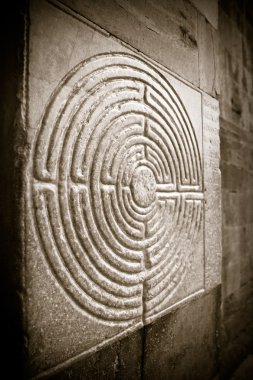Labyrinth carved on stone - sepia toned clipart