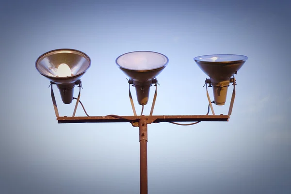 Three projectors of light against the sky background — Stock Photo, Image