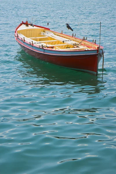 Wooden red boat in a calm lake — Stock Photo, Image