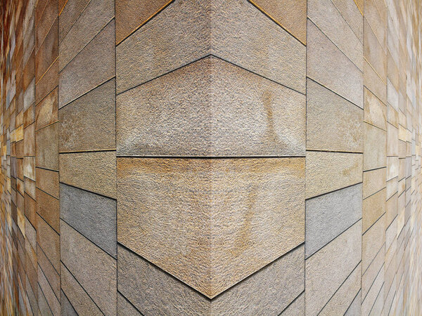 Уголок новой выполненной современной каменной стены из блоков цементной плиты с поверхностным слоем под названием вентилируемая стеновая система для улучшения тепловых характеристик и свойств.