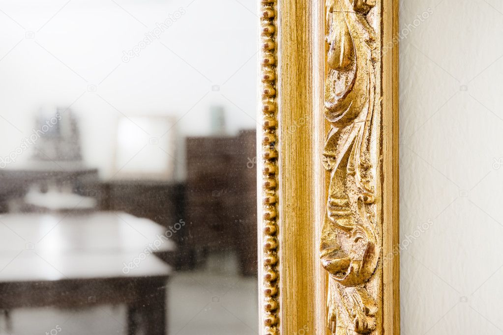 Detail of a carved and golden wooden frame 