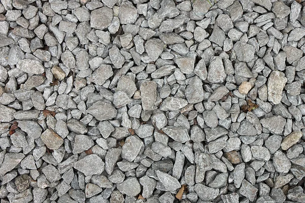 Petites pierres sur un sol avec du sable pour fond, design — Photo