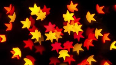 Kıvılcım saçan yıldız şeklindeki ışıklar arka planda