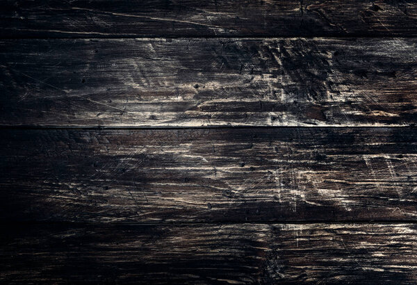 Black wood scratched desk board texture. Abstract background, empty template, text space.