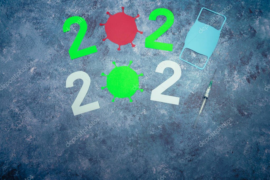 Year of the vaccine 2021. Mask, bacteria, vaccine. COVID-19. Symbolic transition from 2020 to 2021 with the use of a face mask and syringe. 2020 and 2021 year sign with space for your text.