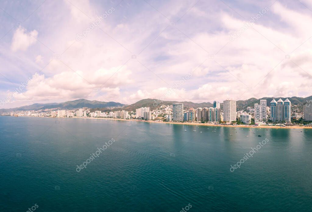 Beautiful view of the beach, aerial view of the sea, acapulco beach seen from above. Travel and vacation concept. Colorful sunset on the beach. Aerial photography