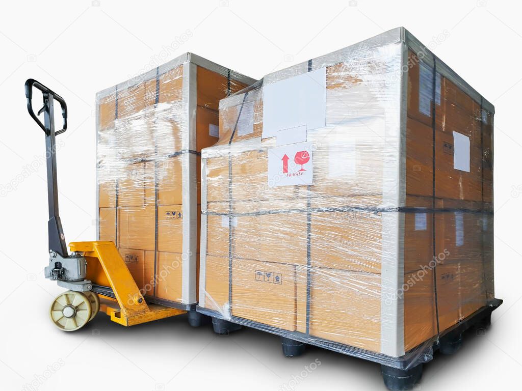 Shipment. Cargo export. Stacked of cardboard boxes on plastic pallets isolated on a white background. Hand pallet truck or manual forklift.
