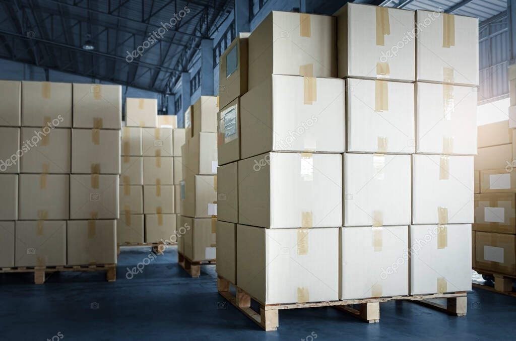 Stack of cardboard boxes on pallet rack in warehouse storage. Shipment. Cargo import and export. Manufacturing industry warehousing store.