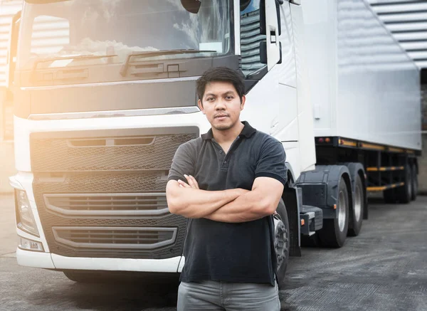 Portrait of Asian A Truck Driver Standing Cross One\'s Arm with Semi Trailer Truck.