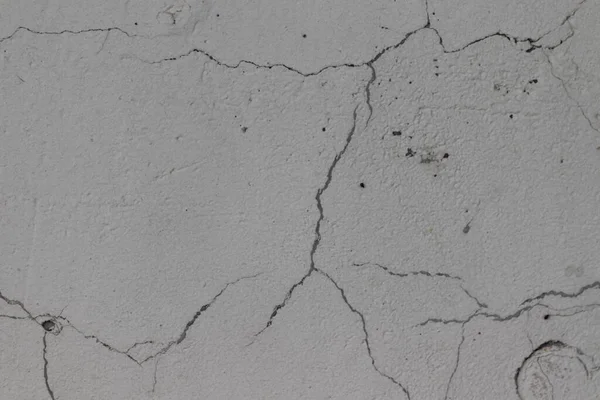 Cracked concrete wall. Cracked texture. Background with the image of a cracked wall.