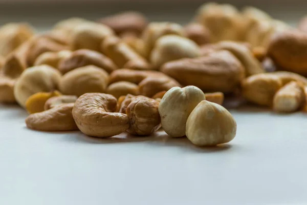 Cashew Nuts Hazelnuts Lie White Background — Fotografia de Stock