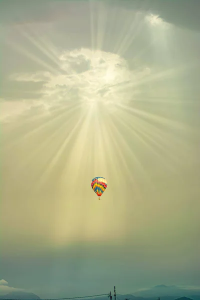 hot air balloon in the middle of a huge sky