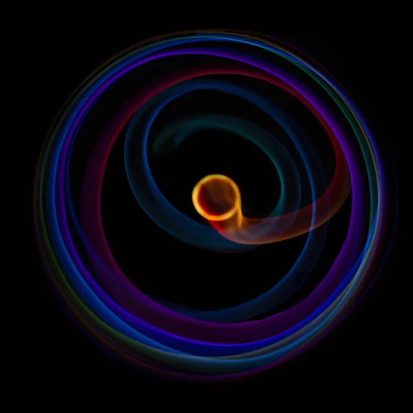 Abstract rotating neon lights texture with black empty copy space inside. colored rainbow rays in a circle and in a frame, on a black background, they are spinning multi-colored