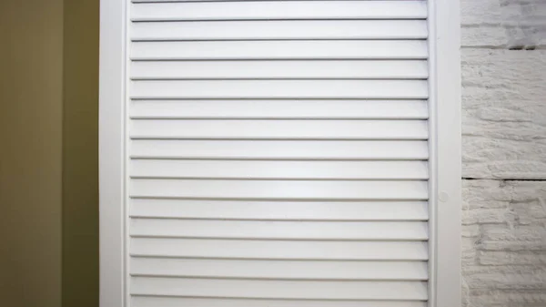 Window with white wooden shutters, interior windows with decorative blinds, beautiful decoration of an apartment or house