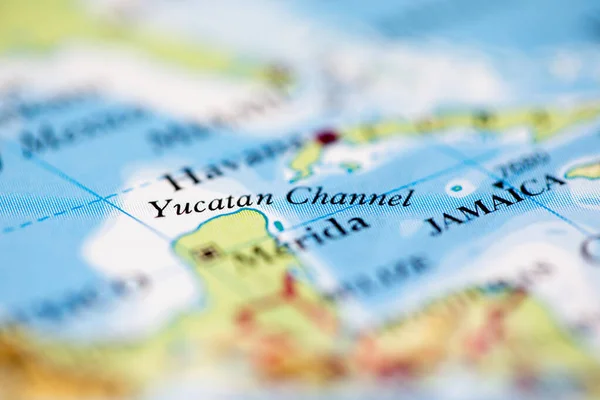 Shallow depth of field focus on geographical map location of Yucatan Channel off coast of Mexico on atlas