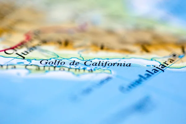 Shallow depth of field focus on geographical map location of Gulfo de California off coast of America on atlas