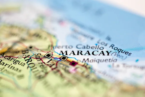 Shallow depth of field focus on geographical map location of Maracay city Venezuela South America continent on atlas