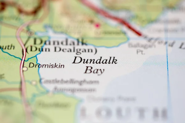 Shallow depth of field focus on geographical map location of Dundalk Bay off coast of Ireland on atlas