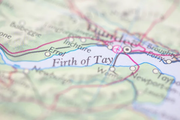 Shallow depth of field focus on geographical map location of Firth of Tay off coast of Scotland on atlas