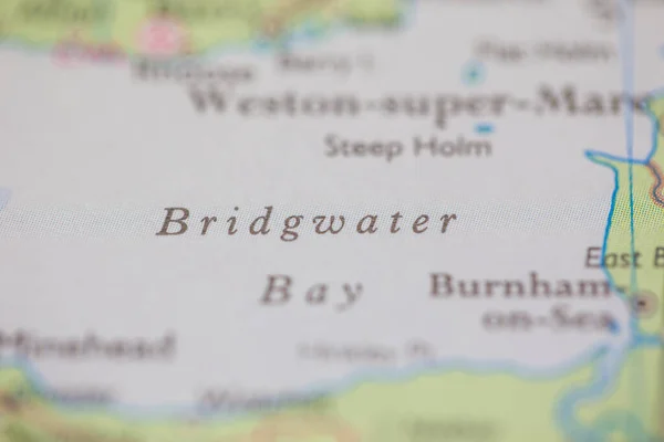 Shallow depth of field focus on geographical map location of Bridgwater Bay off coast of United Kingdon on atlas
