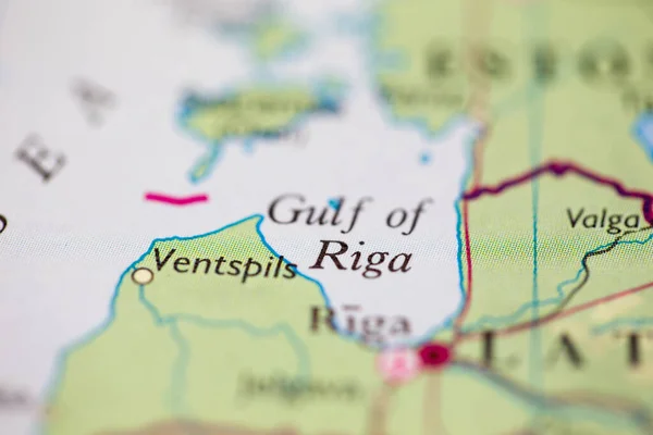 Shallow depth of field focus on geographical map location of Gulf of Riga off coast of Latvia on atlas