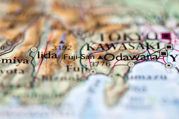 Shallow depth of field focus on geographical map location of Mount Fuji in Japan Asia continent on atlas