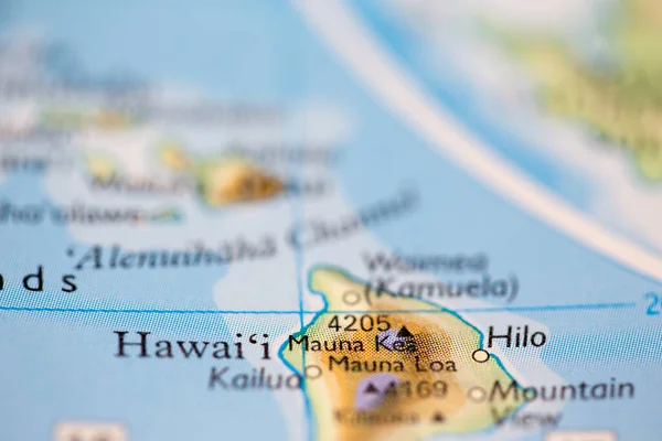 Shallow depth of field focus on geographical map location of Mount Mauna Kea in Hawaii United States North America continent on atlas
