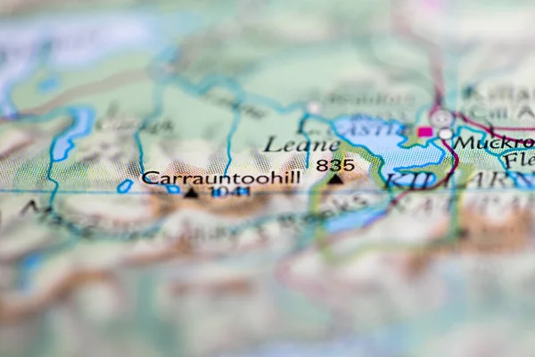 Shallow depth of field focus on geographical map location of Mount Carrauntoohil in Ireland Europe continent on atlas