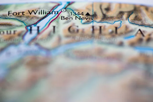 Shallow depth of field focus on geographical map location of Mount Ben Nevis in Scotland Europe continent on atlas