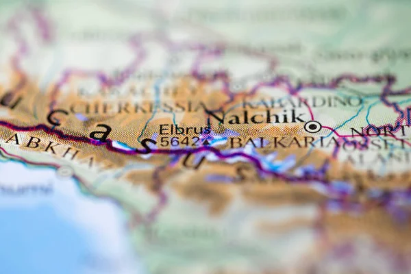 Shallow depth of field focus on geographical map location of Mount Elbrus in Russia Europe continent on atlas