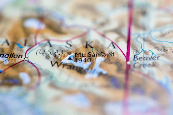 Shallow depth of field focus on geographical map location of Mount Sanford in United States North America continent on atlas